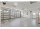 Spacious three car garage with ample room for parking and storage, perfect for car enthusiasts at 7328 Blue Skies Dr, Spring Hill, FL 34606