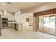 Open kitchen featuring stainless steel appliances, tiled floor, and sliding doors to the patio at 7328 Blue Skies Dr, Spring Hill, FL 34606