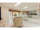 Open living room features tile floors, skylights and sliders to the patio at 7328 Blue Skies Dr, Spring Hill, FL 34606