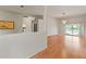 Bright living room with wood floors, chandelier, and sliding doors to the pool at 7328 Blue Skies Dr, Spring Hill, FL 34606