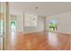 Spacious living room with hardwood floors, large window, and neutral walls offers versatility at 7328 Blue Skies Dr, Spring Hill, FL 34606