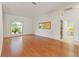 Bright living room featuring hardwood floors and a large window with decorative valance at 7328 Blue Skies Dr, Spring Hill, FL 34606