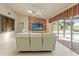 Comfortable living room featuring a view of the pool, tile floors, and built-in shelves at 7328 Blue Skies Dr, Spring Hill, FL 34606