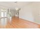 The open living room with hardwood floors, a chandelier, and multiple entry points creates a welcoming space at 7328 Blue Skies Dr, Spring Hill, FL 34606
