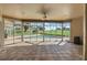 The tiled sunroom offers picturesque views of the screened pool and golf course at 7328 Blue Skies Dr, Spring Hill, FL 34606