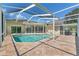 Stunning pool area with ample patio space and screened enclosure, designed for comfortable outdoor gatherings at 7328 Blue Skies Dr, Spring Hill, FL 34606