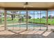 Bright sunroom overlooking a sparkling pool and lush golf course, perfect for relaxation and entertaining at 7328 Blue Skies Dr, Spring Hill, FL 34606