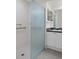 Bathroom with glass shower and white vanity at 7445 Nature Walk Dr, Spring Hill, FL 34606