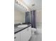 Bathroom featuring granite countertop, white cabinets, updated fixtures, and a shower with gray curtain at 7445 Nature Walk Dr, Spring Hill, FL 34606