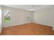 This is a spacious bedroom with hardwood floors and bright windows at 7445 Nature Walk Dr, Spring Hill, FL 34606