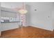 Open concept dining room with hardwood floors, chandelier, and a pass-through to the kitchen at 7445 Nature Walk Dr, Spring Hill, FL 34606