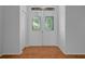 Inviting entryway with double doors, decorative glass, and hardwood floors that add warmth and character at 7445 Nature Walk Dr, Spring Hill, FL 34606