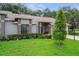 Well-manicured lawn with decorative shrubs and a charming bench on the front porch of the home at 7445 Nature Walk Dr, Spring Hill, FL 34606
