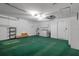Spacious garage featuring storage cabinets, washer and dryer, storage shelves, and green carpet at 7445 Nature Walk Dr, Spring Hill, FL 34606