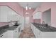Bright kitchen features stainless steel sink, granite counters and white cabinets at 7445 Nature Walk Dr, Spring Hill, FL 34606