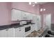 Charming kitchen features white appliances and cabinets with granite counters at 7445 Nature Walk Dr, Spring Hill, FL 34606