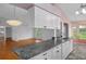 Open kitchen features granite counters overlooking breakfast area and living room at 7445 Nature Walk Dr, Spring Hill, FL 34606
