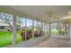 Relaxing enclosed lanai with tile floors and large windows showcasing a beautiful view of the backyard at 7445 Nature Walk Dr, Spring Hill, FL 34606