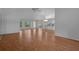 Open-concept living area with sleek hardwood floors, plenty of light, and a view into the adjacent kitchen at 7445 Nature Walk Dr, Spring Hill, FL 34606