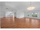Open floor plan living room showcasing a mirrored wall and a chandelier, open to the kitchen at 7445 Nature Walk Dr, Spring Hill, FL 34606