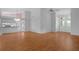 Bright and airy living room with hardwood floors, high ceilings, and seamless access to the kitchen at 7445 Nature Walk Dr, Spring Hill, FL 34606