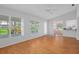 Open floor plan living room with hardwood floors and windows overlooking the backyard at 7445 Nature Walk Dr, Spring Hill, FL 34606