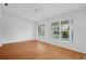 Bright living room with hardwood floors and two large windows offering ample natural light at 7445 Nature Walk Dr, Spring Hill, FL 34606