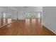 Spacious living room featuring hardwood floors, bright windows, and ample space for versatile furniture arrangements at 7445 Nature Walk Dr, Spring Hill, FL 34606
