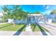 Charming single-story home featuring a lush green lawn, mature tree, and well-maintained landscaping at 750 Lantana Ave, Clearwater, FL 33767