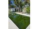 View of the rectangular pool with dark green water requiring maintenance at 750 Lantana Ave, Clearwater, FL 33767