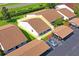 An aerial view of a townhome with well-kept landscaping and assigned parking at 7715 Radcliffe Cir, Port Richey, FL 34668