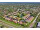 Aerial view with arrow showing location in a well-maintained community with pool and pond at 7715 Radcliffe Cir, Port Richey, FL 34668