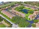 Aerial view of a peaceful neighborhood featuring manicured lawns and a serene water feature at 7715 Radcliffe Cir, Port Richey, FL 34668