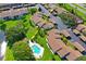 Aerial view of a complex with a community pool and assigned parking spaces at 7715 Radcliffe Cir, Port Richey, FL 34668
