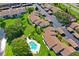 An aerial view of a complex with community pool and assigned parking spaces at 7715 Radcliffe Cir, Port Richey, FL 34668