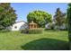 Tranquil backyard featuring a wooden gazebo surrounded by lush greenery at 7715 Radcliffe Cir, Port Richey, FL 34668