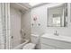 Bright bathroom with shower-tub, single sink vanity, and tiled flooring at 7715 Radcliffe Cir, Port Richey, FL 34668