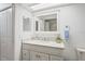 Updated bathroom featuring a vanity with a marble countertop and tiled floors at 7715 Radcliffe Cir, Port Richey, FL 34668