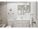 Bright bathroom features shower-tub, single sink vanity, and mirrored backsplash at 7715 Radcliffe Cir, Port Richey, FL 34668