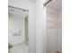 Clean white bathroom with shower and closet with wire shelving at 7715 Radcliffe Cir, Port Richey, FL 34668