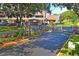 Gated entrance to the community, showcasing lush landscaping and mature trees at 7715 Radcliffe Cir, Port Richey, FL 34668