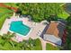 Aerial view of a community pool with ample lounge chairs and lush landscaping at 7715 Radcliffe Cir, Port Richey, FL 34668