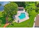 An aerial view of a community pool with lounge chairs and lush greenery at 7715 Radcliffe Cir, Port Richey, FL 34668