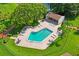 An aerial view of a community pool with lounge chairs and nearby shade at 7715 Radcliffe Cir, Port Richey, FL 34668