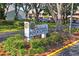Community sign amidst lush landscaping at 7715 Radcliffe Cir, Port Richey, FL 34668