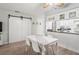 Dining room with adjacent kitchen featuring modern appliances and a dark countertop at 7715 Radcliffe Cir, Port Richey, FL 34668
