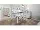 Dining room view with access to bright kitchen with modern appliances and dark countertops at 7715 Radcliffe Cir, Port Richey, FL 34668