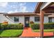 Charming single-story home with a well-manicured lawn and colorful walkway leading to the front door at 7715 Radcliffe Cir, Port Richey, FL 34668