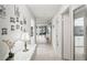 Inviting hallway with tiled floor, white console table, and views into the living areas at 7715 Radcliffe Cir, Port Richey, FL 34668
