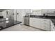 Modern kitchen with stainless steel appliances, white cabinets, granite countertops, and patterned backsplash at 7715 Radcliffe Cir, Port Richey, FL 34668